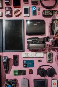 pexels-photo-27926532-27926532 Assorted vintage electronics displayed on a pink surface.